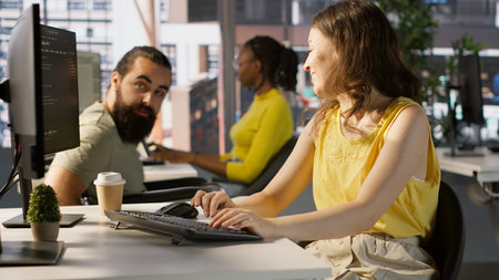 Man with paraplegia drinking coffee, checking progress done by employee doing code review to fix...