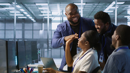 Data center coworkers having fun while maintaining network infrastructure. Server hub colleagues...