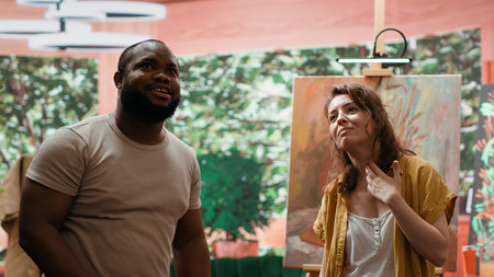 Painters use a hologram to create masterpiece with watercolor paint, finger painted artwork. Creative talented team of artists showing their creativity for a rustic modern painting.の写真素材