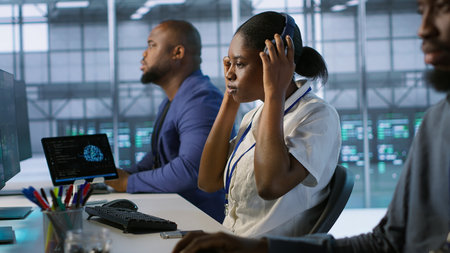 Woman putting headphones on in server room, developing disaster recovery plans ensuring minimal downtime. Engineer listening music in data center, using data analytics to monitor performance, camera Aの写真素材