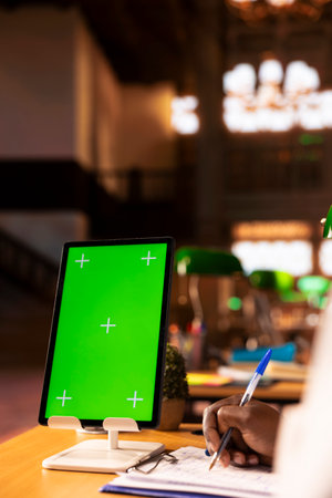African american student learning to become a doctor next to copy space, taking notes after studying case files. Young man future doctor sitting at the campus library, med school. Close up.の写真素材