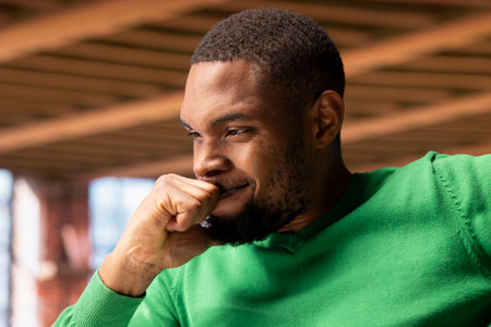 Smiling man in home office desk feeling proud after seeing he achieved sales target on laptop screen. Remote employee rejoicing after receiving promotion at work, reading email, close upの写真素材