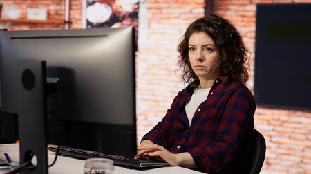 AI startup company developer testing company software to minimize occurrence of bugs, identifying bottlenecks. Woman in office writing code in programming language to reduce errorsの写真素材