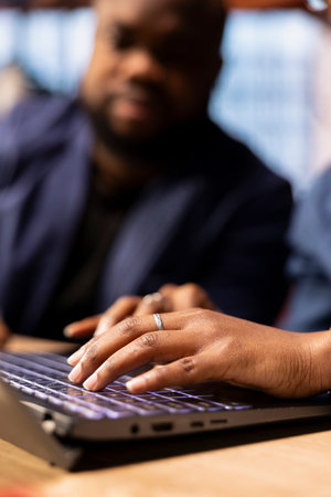 African American man and woman sits at a stylish home office, brainstorming ideas for their digital...