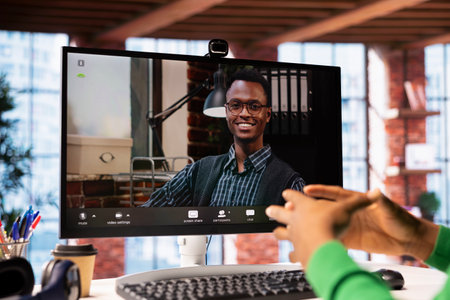 Man at home engaging in a video call with smiling psychologist using PC, listening to advice. Close...