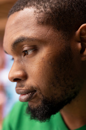 Pensive moody person with focused expression thinking, side profile close up shot. Detailed shot of african american adult man indoors with reflective look on face concentratingの写真素材