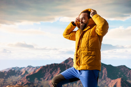 Young traveler enjoys the serenity of the high altitude wilderness, stunning landscape and peaceful surroundings. Nature lover feeling happy climbing to the mountain top, expedition.の写真素材