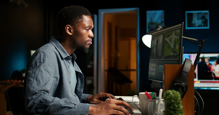 Video maker producing montage with artistic software for color adjustment, special effects in movie editing. Digital media illustrator developing transitions for cinematic production.の写真素材