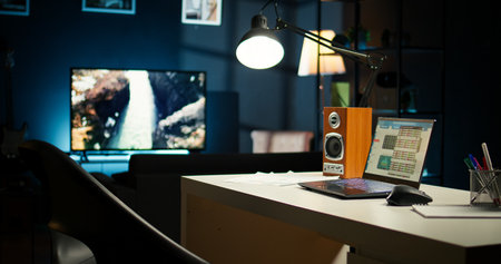 Cozy urban loft apartment with a contemporary home office setup. Wooden furniture, a TV and house plants highlighting the modern stylish interior design, blending comfort and creativity.の写真素材
