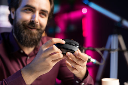 Close up of joyful influencer endorsing wireless mouse, showing functionalities. Excited internet...