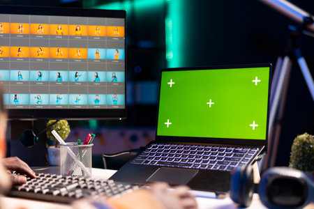 Creative african american graphic designer editing images next to copy space on dual monitors,...