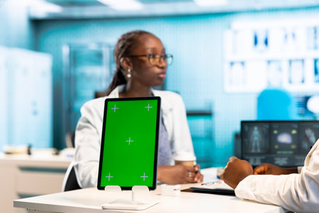 General practitioner woman consulting a black girl for treatment and diagnostic results, leveraging health data and expertise in a clinic environment. Helping with recovery.の写真素材