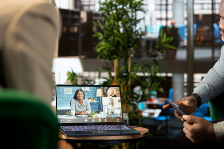 Manager discussing with collaborators working from home, holding videoconference meeting using...