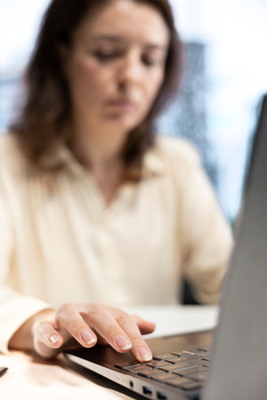 Young female general director working on corporate management, analyzing data driven analytics and...
