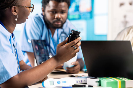 Male and female young nurses in scrubs engaged in professional training and research with expert...