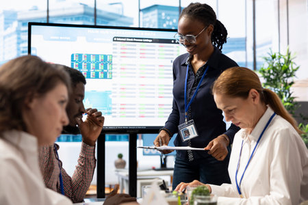 Business analyst creating an interactive board presentation with project updates and goals to ensure...