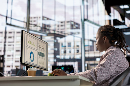 African american manager analyzing company data for strategic planning, solving resource allocation...