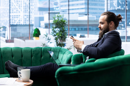 Motivated boss working tirelessly in a high end downtown workspace, reviewing financial forecasts...