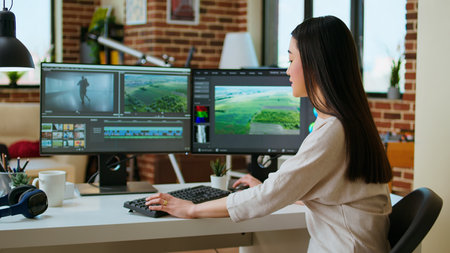 Female filmmaker working on post production from home office, editing timelines and color grading...