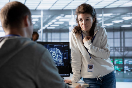 Team of engineers using machine learning to optimize data center operations, improving efficiency of...