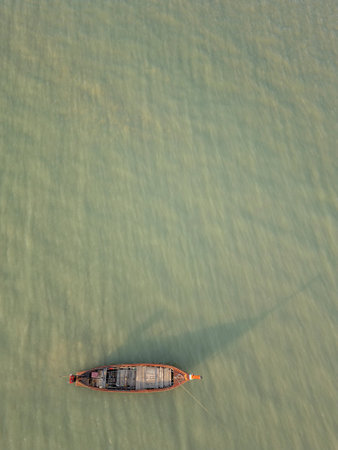 Drone shot of a stunning small island with sailboats around the shore, amazing travel destination...