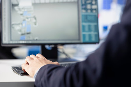 Solar panels manufacturing technician developing new photovoltaic materials and technologies using PC. Close up of photovoltaics factory expert conducting experiments on computerの写真素材