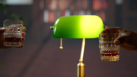 Businessmen clinking glasses of scotch and saying cheers, feeling excited about collaborating on making a fortune. Old money elite society members negotiate at social club. Close up. Camera B.の写真素材