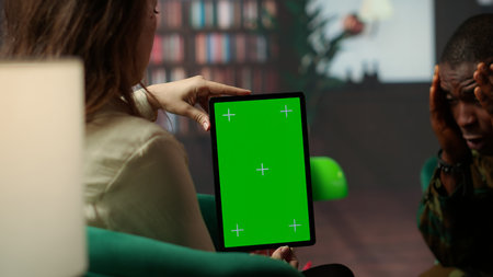 Psychotherapy session for a military veteran in distress with mockup screen, showcasing counseling support for PTSD and trauma after combat. Armed forces soldier with war flashbacks. Camera B.の写真素材