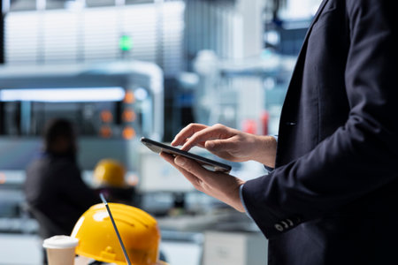 Operations director in a solar panel factory monitoring efficiency metrics and system outputs,...