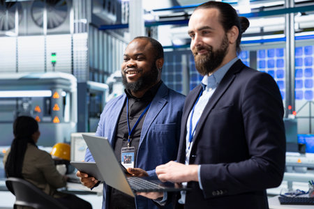 Factory inspectors and supervisors engaging in briefing over production metrics, supporting industrial innovation and sustainable process improvement. Solar power manufacturing.の写真素材