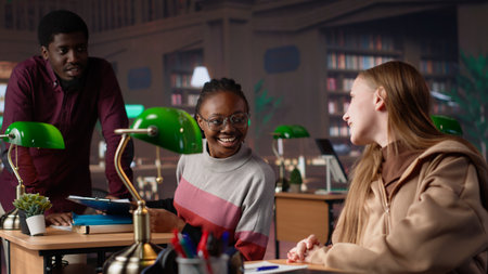 Female pupil reviewing the educational research collection at the library, studying for her exams to...