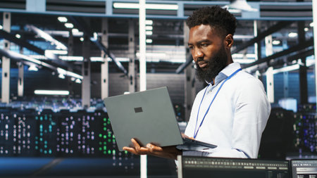Data center programmer uses node tree software to identify equipment performance issues. African...