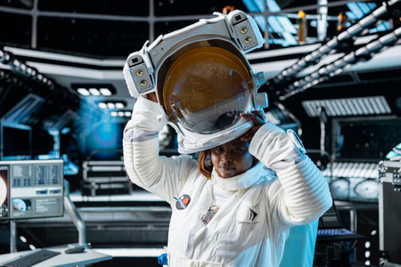 Portrait of female cosmonaut putting on cosmic gear helmet, preparing for planetary mission outside....