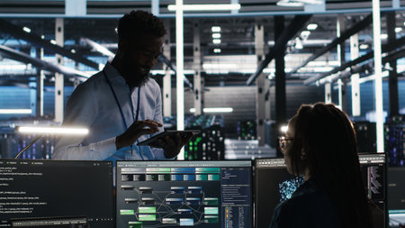 Server hub manager talking with programmer using node tree software to optimize system health. Data center supervisor overseeing IT expert analyzing equipment issues using AI visualization, camera Bの写真素材