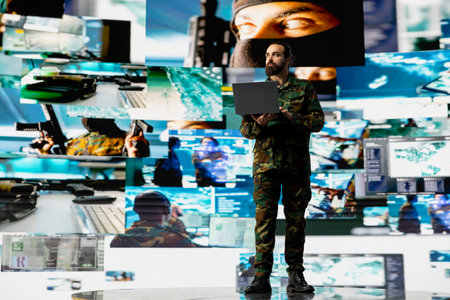 Defense forces officer reviews surveillance and digital systems, getting combat ready with warfare...