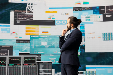 Modern business leader thinking about new successful ideas to increase his company profits, using insight and KPI projections or models to help guide strategic decision making.の写真素材