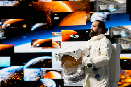Young cosmonaut in a space suit floats in orbit above Earth, symbolizing the journey of humanity into cosmos. Endless pursuit of discovery, technology and exploring the unknown universe.の写真素材