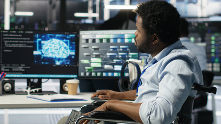 Engineer using wheelchair in data center using AI node tree software to minimize system downtime....