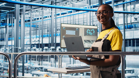 Portrait of happy engineer in smart photovoltaics factory looking at system performance metrics. Cheerful worker in solar panels plant tracking energy production through IoT sensors, camera Aの写真素材