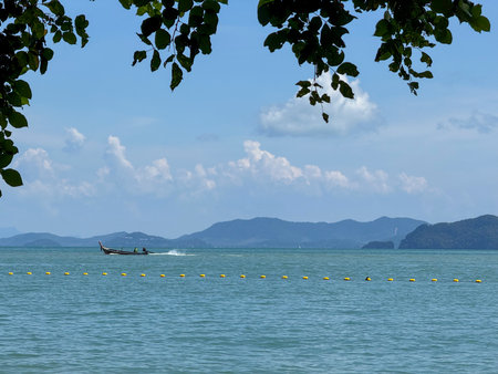 Exotic scenery of amazing small islands capturing the beauty of Thailand, coastline where waves meet soft sand under a bright summer sky. Tropical stunning sandy lagoon beach.の写真素材
