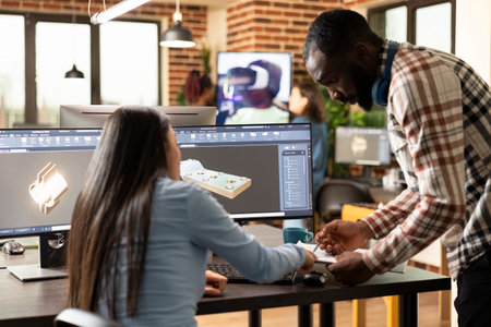 Professional male and female engineers designing an industrial engine prototype with CAD tools. Diverse creative experts exchanging ideas and sketching mechanical components on a multi monitor.の写真素材