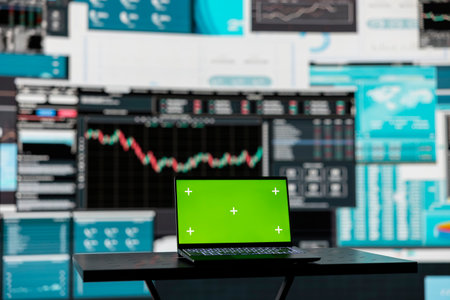 In a business related space, laptop display shows green screen to help with strategy planning with financial data. Representing modern artificial intelligence and productivity for growth.の写真素材