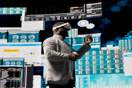 Black administrator reviewing big data with virtual reality headset, working hard on business development to increase funds. Analyzing monthly reports for productivity and success.の写真素材