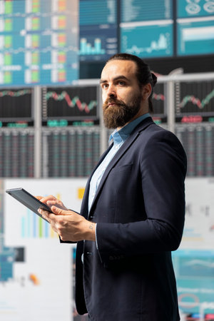 Entrepreneur with vision reviewing digital dashboard and charts, ensuring strategic planning with...
