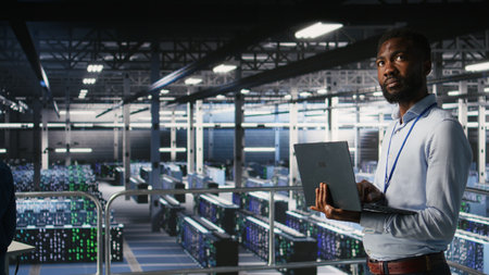 Engineers in data center using laptop to monitor neural network LLM visualization. Coworkers on...