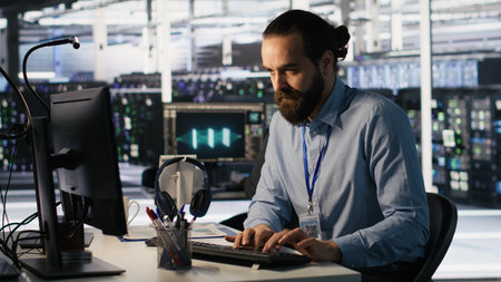 Angry data center engineer banging fist on desk after seeing system failure. Server farm IT expert...