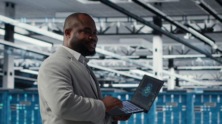 Smiling data center technician installing and upgrading hardware components. Happy server farm...