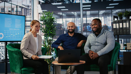 Diverse business professionals engaged in a video call global meeting, using online communication...