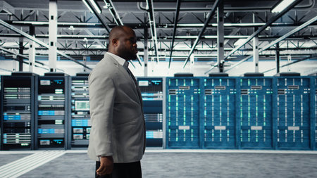 System administrator walking in data center with rigs handling queries, doing backups. Admin...
