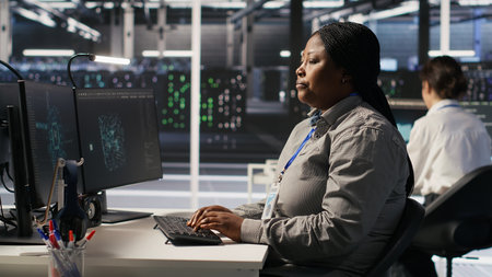 Data center employee making a hand gesture toward a colleague. Woman in a server hub communicating...